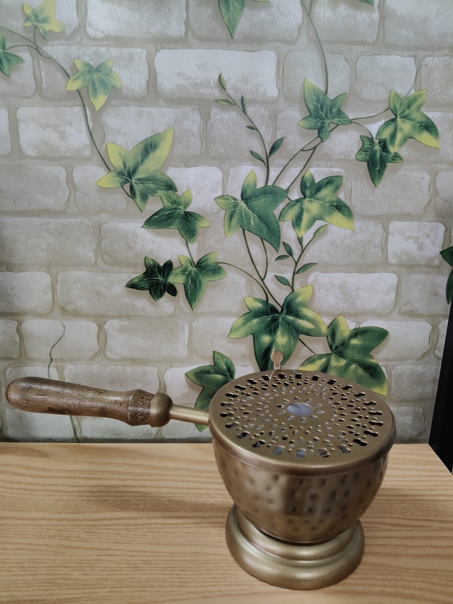 Brass burner with handle. Removable lid.