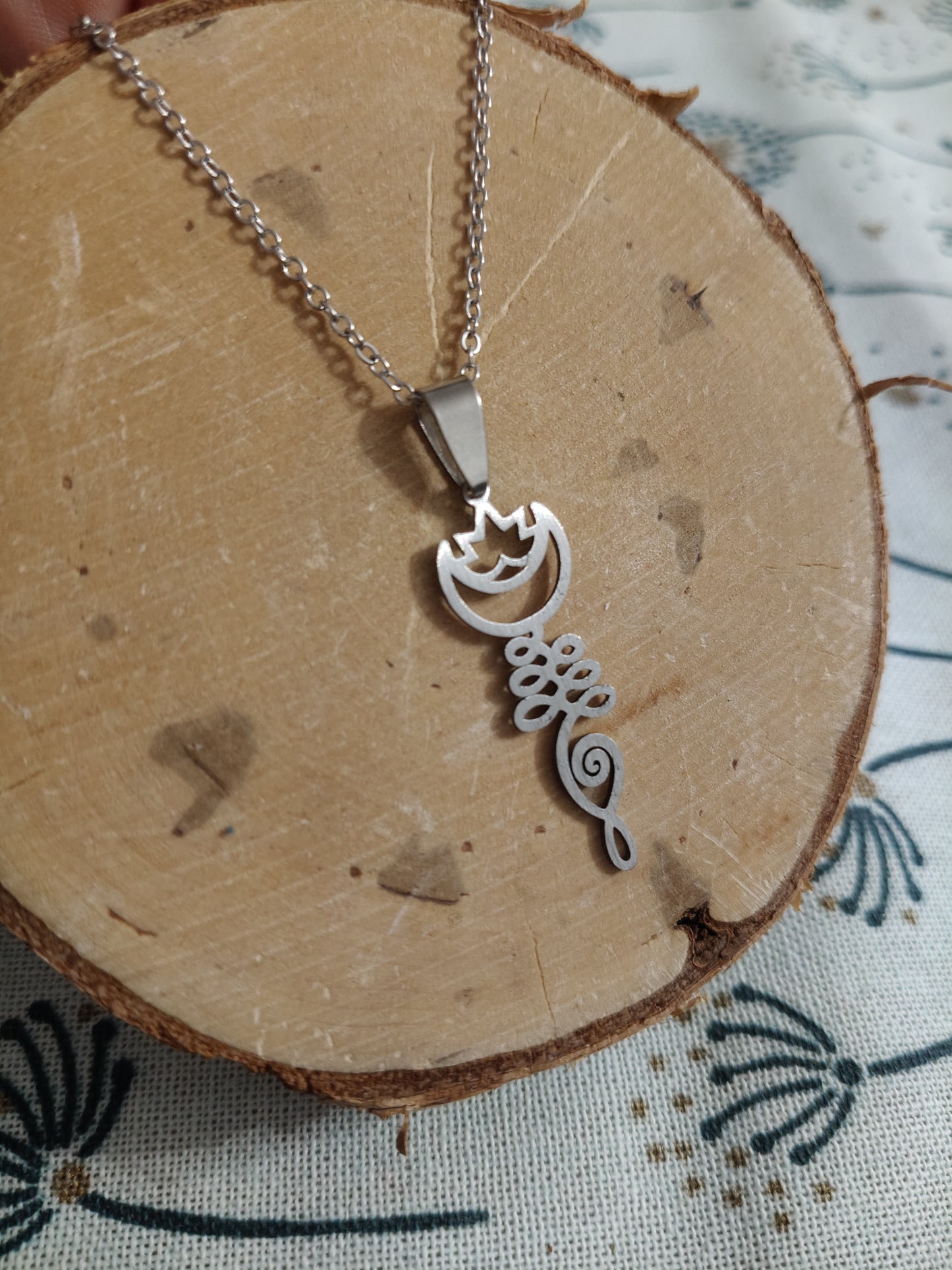 Stainless steel pendant with a lotus flower, moon, and the goddess of fertility.